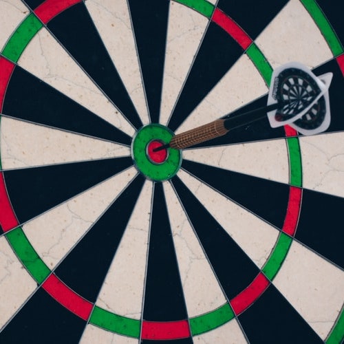 a dart sticks into the center of a dartboard