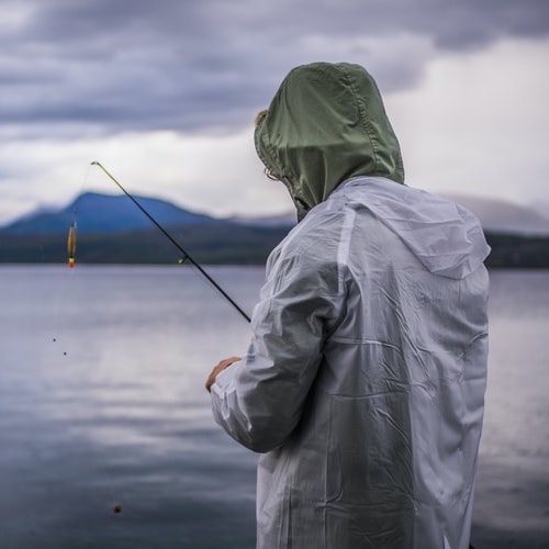 person fishing on body of water